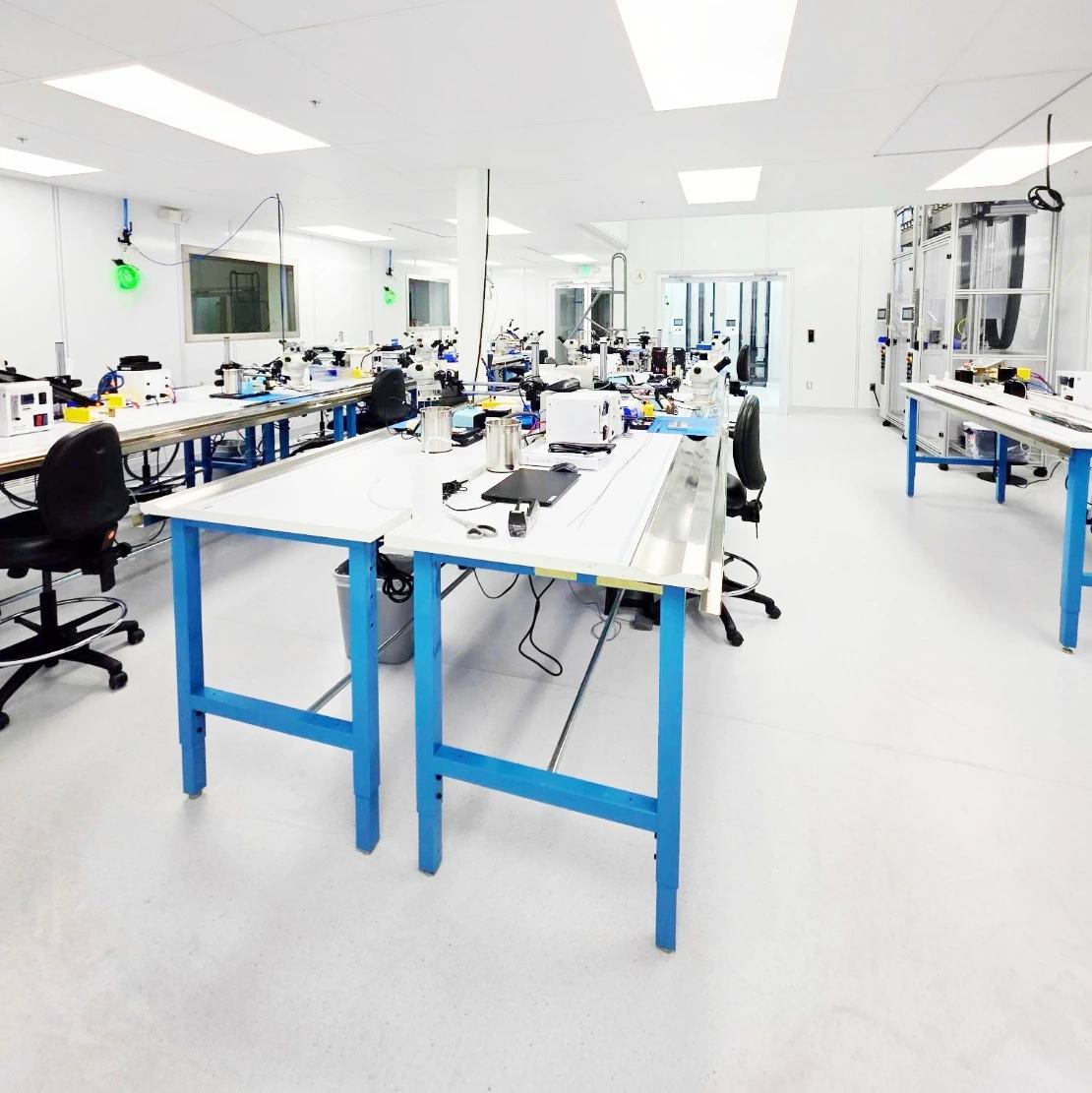 Open bench space inside the MedTech Innovation, LLC Class 10,000 cleanroom, with microscope stations and process equipment