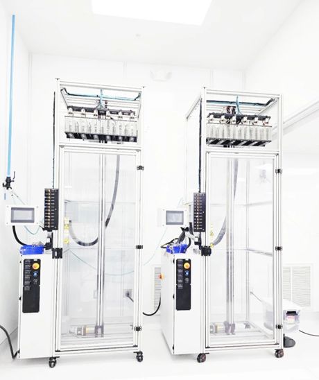 Two automated hydrophilic dip-coating towers with touchscreen controls and multi-position dispense manifolds