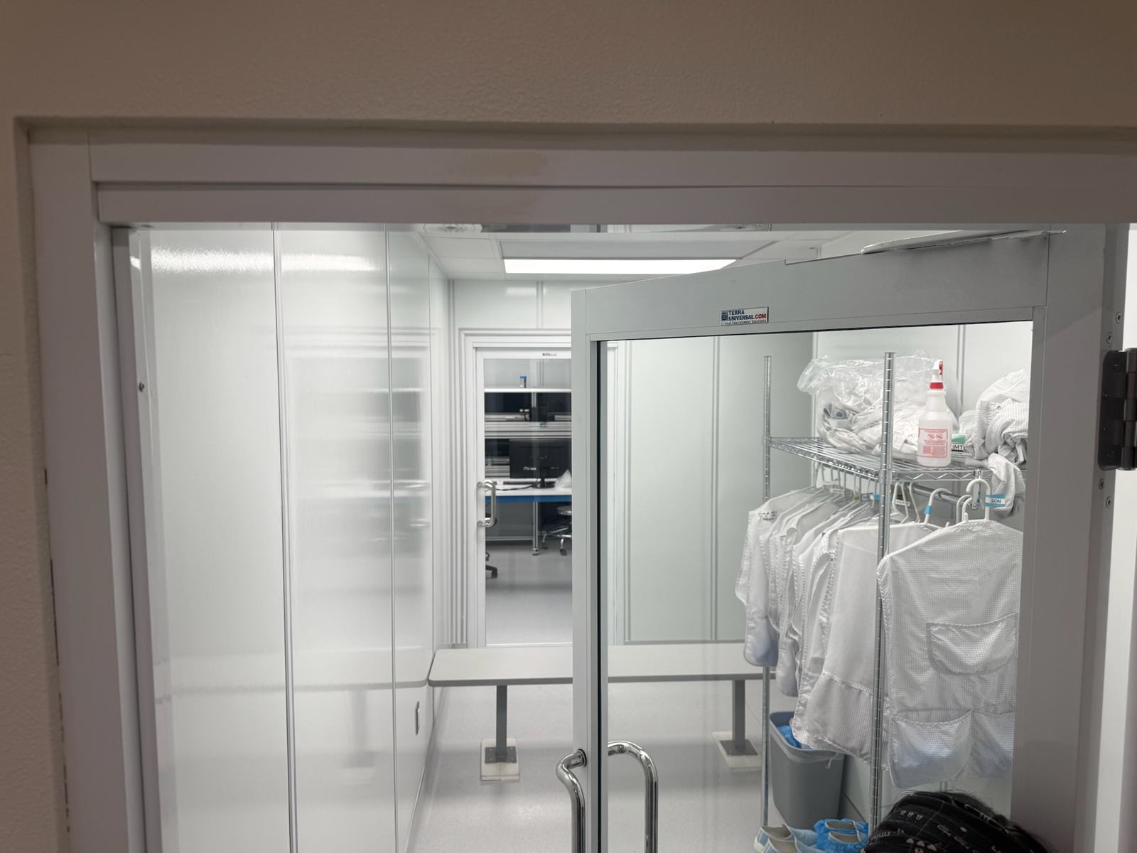 Gowning room with coveralls staged on hangers