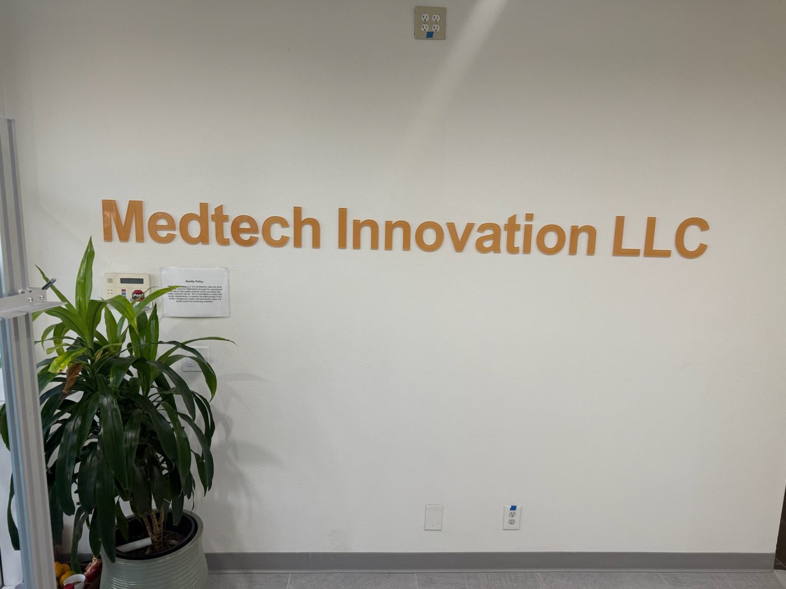 MedTech Innovation lobby wall with company name and posted quality policy